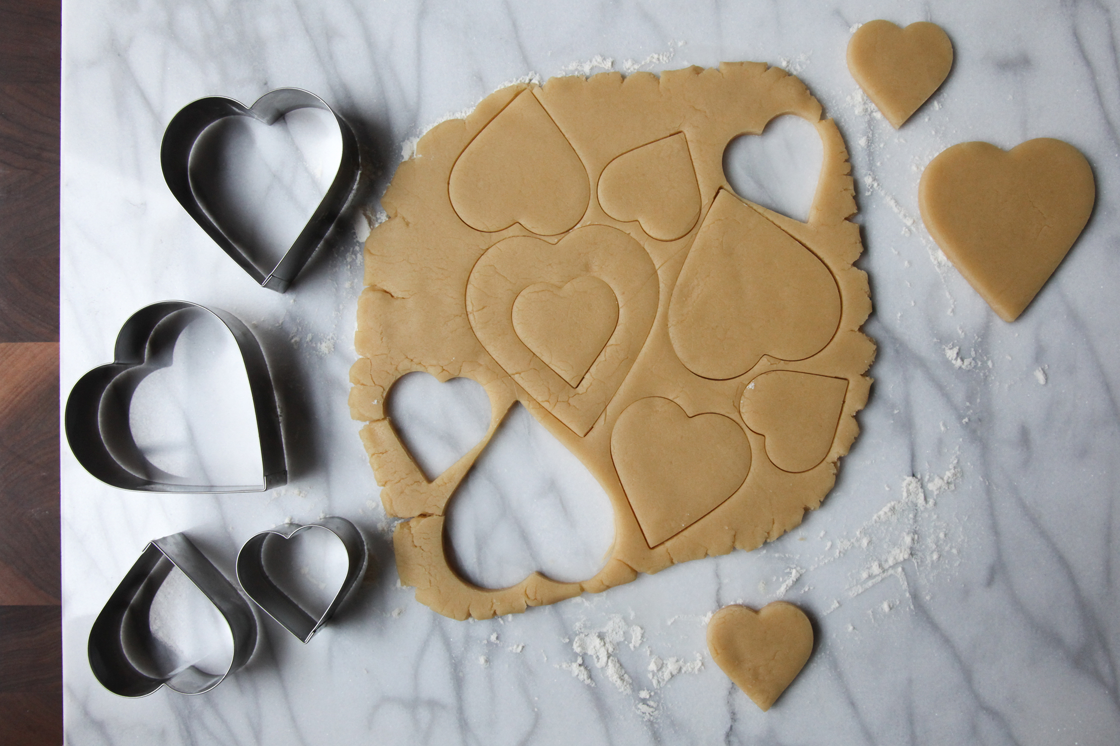 Cutting out heart sugar cookies