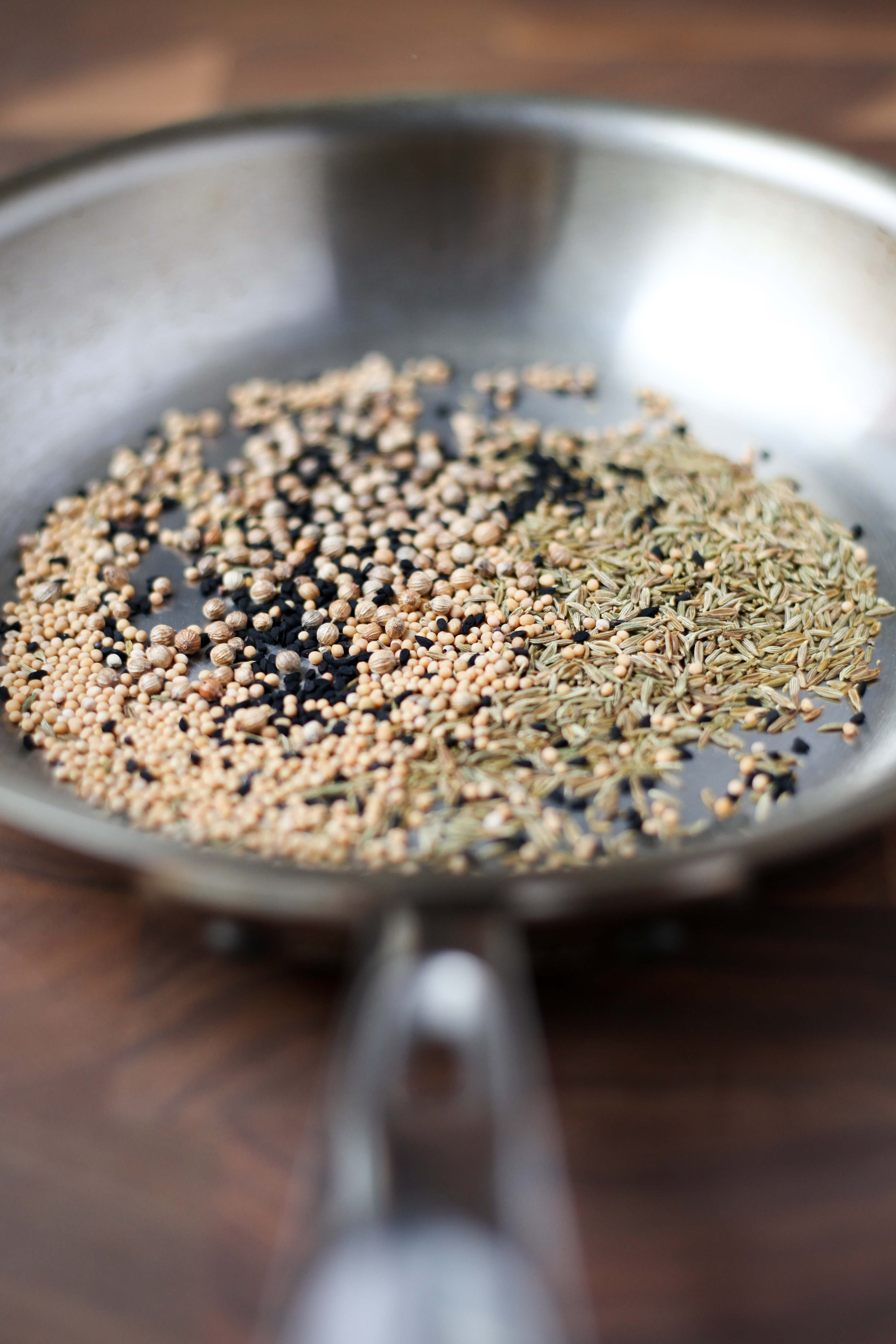 Toasting cumin, coriander, and nigella seeds