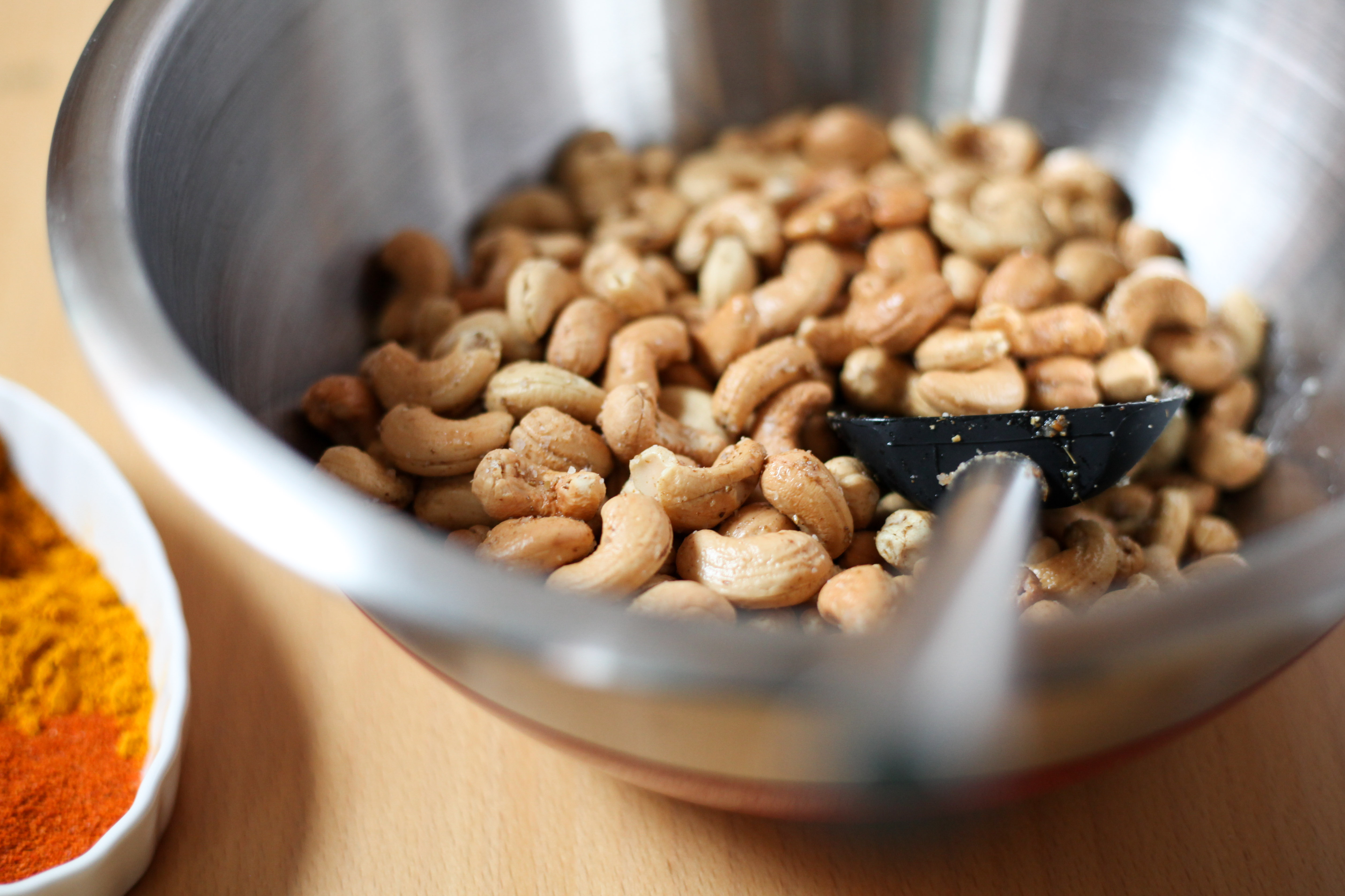 Tossing cashews with spices