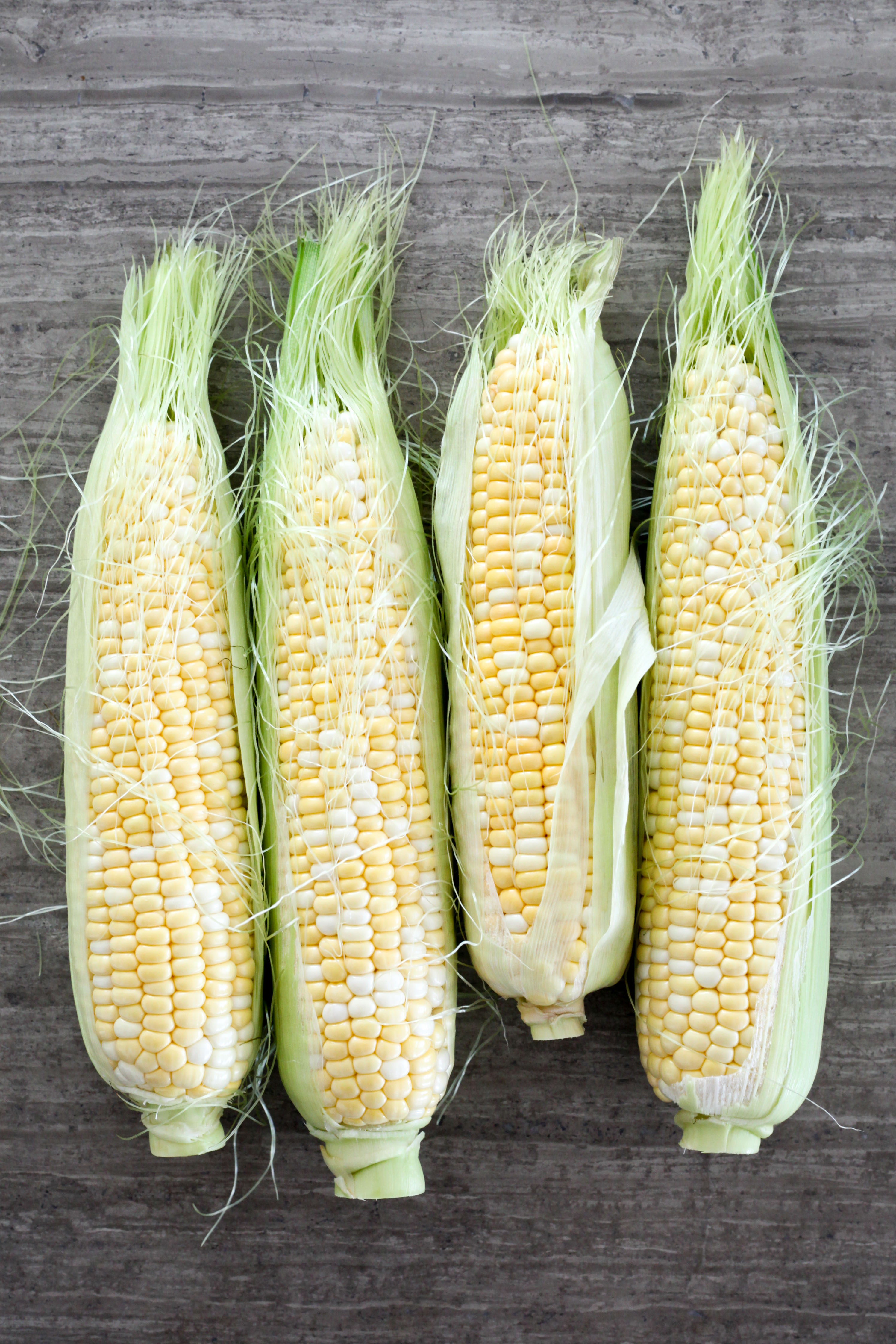 Partially-shucked corn on the cob