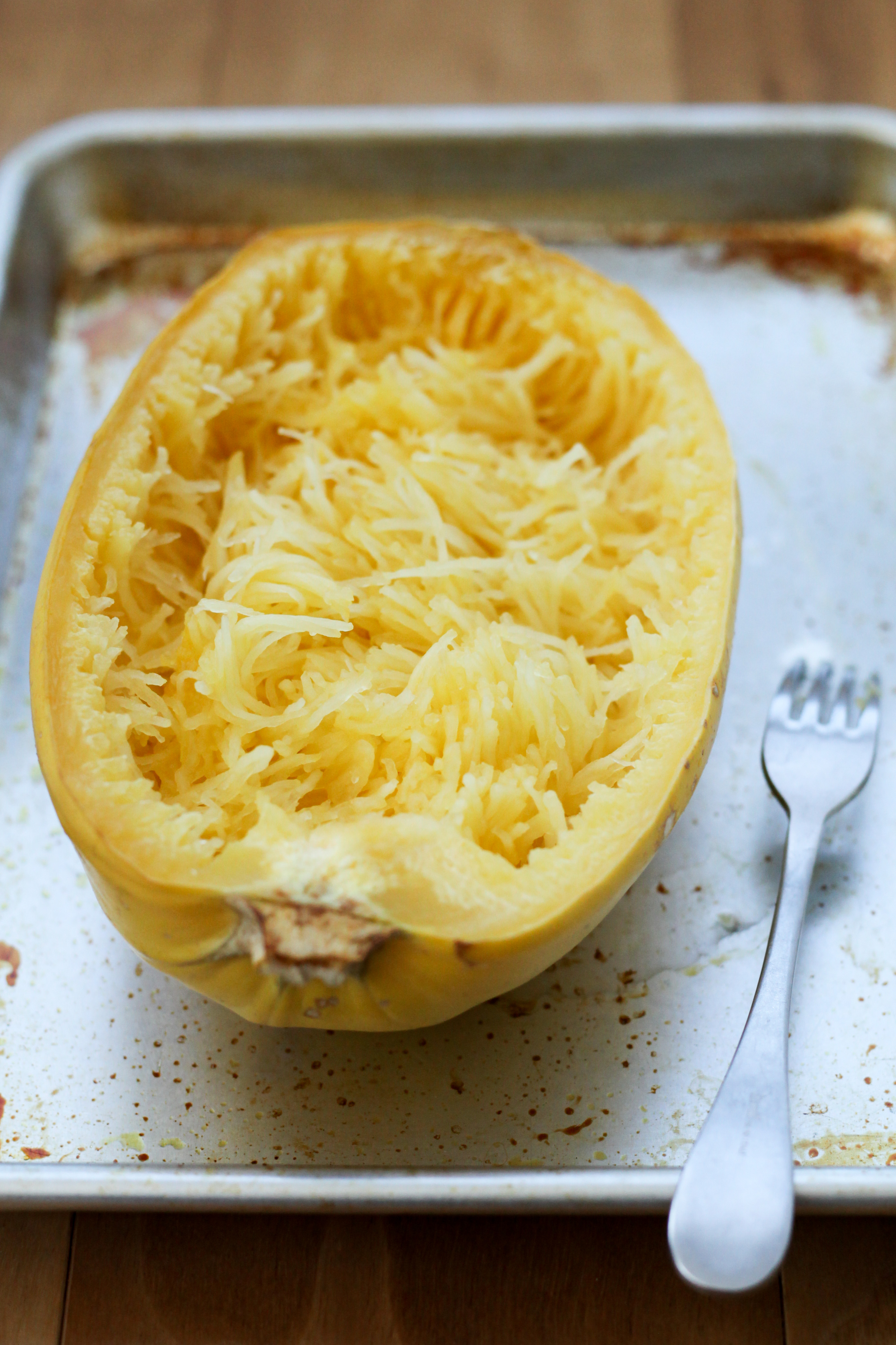 Scooping out spaghetti squash flesh