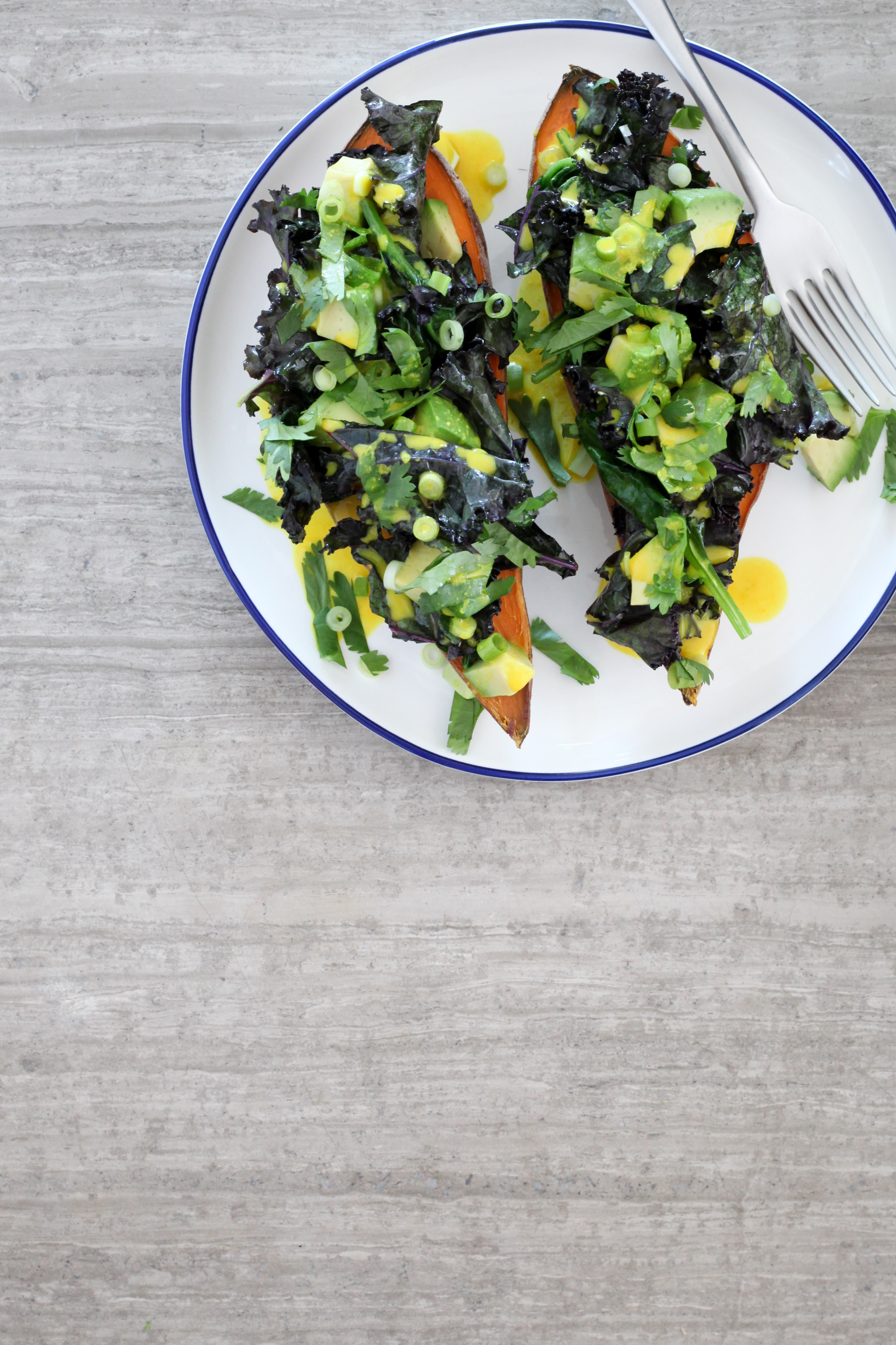 Baked Sweet Potato With Spinach, Kale, and Avocado with Turmeric-Tahini Dressing | amodestfeast.com | @amodestfeast